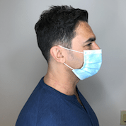 Profile shot of a man wearing a protective face mask