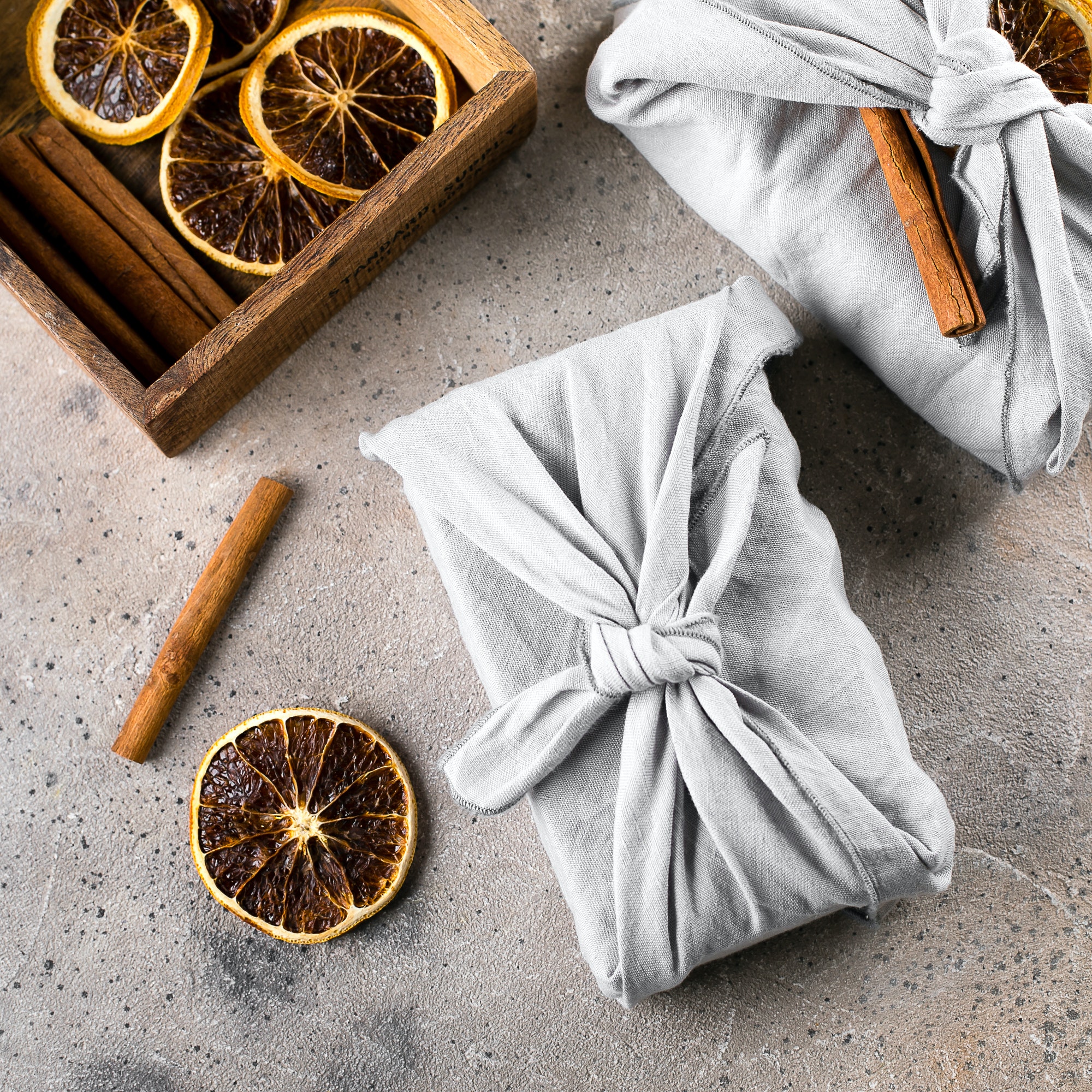 Holiday eco-friendly fabric reusable gift packaging with dry orange and cinnamon. Zero waste concept