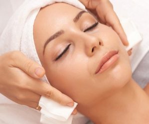 Beautiful young woman with flawless skin enjoying professional facial with Microneedling in beauty salon